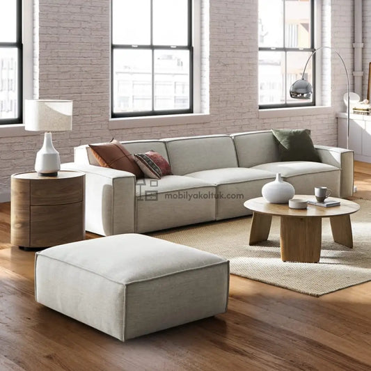 Açık gri kumaş kaplı modern tasarımlı modüler köşe koltuk geniş oturma alanı ile
